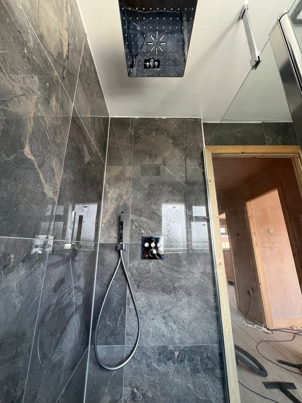 Luxury marble tile walk-in shower with rainfall head